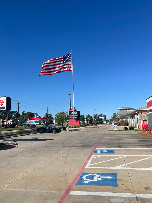 80' x 12'' x .375" 4-piece tapered aluminum commercial flagpole. External rope windloading is 144 MPH unflagged.